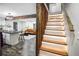 Modern illuminated staircase with kitchen and living room view at 3545 W Custer Pl, Denver, CO 80219