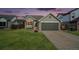 House exterior at dusk with driveway at 6727 E 123Rd Dr, Thornton, CO 80602