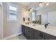 Well-lit bathroom featuring a large mirror, dual vanity sinks, and modern fixtures with ample counter space at 21261 E 60Th Ave, Aurora, CO 80019