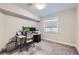 This carpeted bedroom features a window for natural light and is currently purposed as a functional office at 21261 E 60Th Ave, Aurora, CO 80019