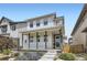 Charming two-story home featuring a welcoming front porch and nicely landscaped front yard at 21261 E 60Th Ave, Aurora, CO 80019