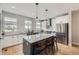 Modern kitchen featuring a large island, stainless steel appliances, and stylish pendant lighting at 21261 E 60Th Ave, Aurora, CO 80019