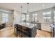 Bright kitchen with an island, stainless steel appliances, and ample counter space for meal preparation at 21261 E 60Th Ave, Aurora, CO 80019