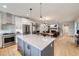 Open-concept kitchen featuring an island, stainless steel appliances, and seamless flow into the living spaces at 21261 E 60Th Ave, Aurora, CO 80019