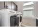 Convenient laundry room with modern washer and dryer units, providing efficient laundry solutions at 21261 E 60Th Ave, Aurora, CO 80019