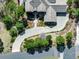 Aerial view of a luxury home featuring a long driveway, lush landscaping, and a tile roof at 648 Ruby Trust Dr, Castle Rock, CO 80108