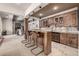 Elegant bar area with granite countertop, custom cabinetry, and pendant lighting at 648 Ruby Trust Dr, Castle Rock, CO 80108