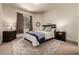 Comfortable bedroom with a bed, a nightstand, a dresser, and a large window at 648 Ruby Trust Dr, Castle Rock, CO 80108