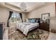 Cozy bedroom with tray ceiling, stylish decor, and large window providing great light at 648 Ruby Trust Dr, Castle Rock, CO 80108