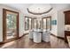 Charming breakfast nook features hardwood floors, modern chandelier, and access to an outdoor balcony at 648 Ruby Trust Dr, Castle Rock, CO 80108