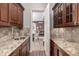 Convenient butler's pantry featuring beautiful countertops, cabinetry, and seamless flow into the dining room at 648 Ruby Trust Dr, Castle Rock, CO 80108