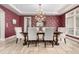 Formal dining room with stylish wallpaper, modern chandelier, and travertine flooring at 648 Ruby Trust Dr, Castle Rock, CO 80108