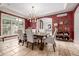 Elegant dining room features rich wallpaper, modern chandelier, and access to an adjacent patio at 648 Ruby Trust Dr, Castle Rock, CO 80108