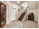 Inviting entryway with a decorative glass door, a staircase, and a stylish round rug at 648 Ruby Trust Dr, Castle Rock, CO 80108