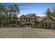 Exterior of a grand home with a large driveway, manicured landscaping, and a welcoming entrance at 648 Ruby Trust Dr, Castle Rock, CO 80108