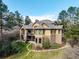 Beautiful home with stone accents, a covered porch, and a meticulously maintained lawn surrounded by mature trees at 648 Ruby Trust Dr, Castle Rock, CO 80108