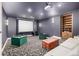 Home theater with projector, screen, comfortable seating, and an adjacent bookshelf at 648 Ruby Trust Dr, Castle Rock, CO 80108
