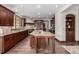 Gourmet kitchen featuring custom cabinets, granite counters, a large island and stainless steel appliances at 648 Ruby Trust Dr, Castle Rock, CO 80108