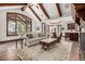 Open concept living room with high ceilings, wood beams, and seamless flow into the dining room and kitchen at 648 Ruby Trust Dr, Castle Rock, CO 80108