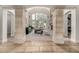 Sophisticated living room framed by stone columns, fireplace, and a wall of windows showcasing the outdoors at 648 Ruby Trust Dr, Castle Rock, CO 80108