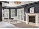 A sitting area, fireplace, and doors to the exterior are featured in this main bedroom at 648 Ruby Trust Dr, Castle Rock, CO 80108