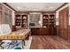 Luxurious home office with custom built-ins, rich wood accents, and ample desk space at 648 Ruby Trust Dr, Castle Rock, CO 80108