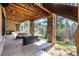 Covered patio with stone accents and outdoor seating, providing a relaxing view of the yard at 648 Ruby Trust Dr, Castle Rock, CO 80108