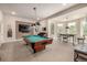 Entertainment room with billiard table and breakfast nook with multiple windows and natural light at 648 Ruby Trust Dr, Castle Rock, CO 80108
