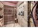 View of a beautifully designed wine cellar featuring custom wine racks, stone accents, and iron door at 648 Ruby Trust Dr, Castle Rock, CO 80108