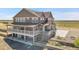 Aerial view of a two-story home with a covered deck and an expansive yard at 49346 E County Road 6, Bennett, CO 80102