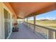 Spacious back porch perfect for outdoor gatherings, offering scenic views of the surrounding landscape at 49346 E County Road 6, Bennett, CO 80102