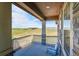 Relax on this back porch with views of the surrounding landscape and comfortable outdoor seating at 49346 E County Road 6, Bennett, CO 80102