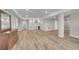 Finished basement showcasing laminate floors, a wet bar, and neutral color scheme at 49346 E County Road 6, Bennett, CO 80102