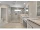 Contemporary bathroom with granite counters, dual sinks, and a glass shower at 49346 E County Road 6, Bennett, CO 80102