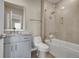 Modern bathroom featuring sleek white cabinets, a granite countertop, and a shower over tub at 49346 E County Road 6, Bennett, CO 80102