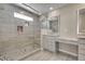 Stylish bathroom with glass enclosed shower, dual sinks, and modern vanity at 49346 E County Road 6, Bennett, CO 80102