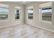 Bright bedroom featuring three large windows with views of the horse property next door at 49346 E County Road 6, Bennett, CO 80102