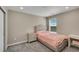 Cozy bedroom with plush carpeting, accent furniture and a bright window at 49346 E County Road 6, Bennett, CO 80102