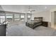 Large primary bedroom with carpet, ceiling fan, and view of the countryside at 49346 E County Road 6, Bennett, CO 80102