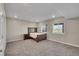 Spacious bedroom with carpet, a wooden bed frame, and a view from the windows at 49346 E County Road 6, Bennett, CO 80102