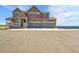 Beautiful two-story home with a covered porch and spacious driveway on a sunny day at 49346 E County Road 6, Bennett, CO 80102