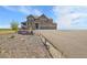 Inviting two-story home with covered porch, three-car garage, and landscaped front yard at 49346 E County Road 6, Bennett, CO 80102