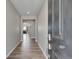 Inviting hallway with wood floors leads into the home, offering a glimpse of the bright living space at 49346 E County Road 6, Bennett, CO 80102