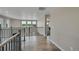 Spacious hallway with wood floors, gray trim and plenty of natural light at 49346 E County Road 6, Bennett, CO 80102