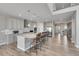 Open concept kitchen featuring a large island with barstool seating and modern stainless appliances at 49346 E County Road 6, Bennett, CO 80102
