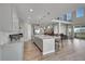 Bright, open-concept kitchen features a large island with bar stool seating and stainless appliances at 49346 E County Road 6, Bennett, CO 80102