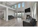 A spacious living room features high ceilings, many windows, fireplace and access to outside deck at 49346 E County Road 6, Bennett, CO 80102
