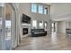 Bright living room featuring a fireplace, high ceilings, a wall of windows and outside access at 49346 E County Road 6, Bennett, CO 80102