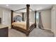 Elegantly styled main bedroom featuring a grand four-poster bed and abundant natural light at 49346 E County Road 6, Bennett, CO 80102