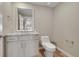 Clean powder room featuring a modern vanity, stylish mirror, and neutral color scheme at 49346 E County Road 6, Bennett, CO 80102